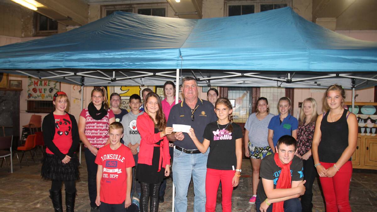 What an excellent addition to the CADAS Kids ‘goods and chattels’ a Gazebo.
This was presented to the Kids by Cootamundra Lions Club and will be invaluable for them when they are out and about at fetes and fairs, not having to stand out in 35 degree heat when doing their face painting.
Pictured here receiving a cheque for $400 as well as handing over the Gazebo are Brianna Hefren (Secretary of CADAS Kids) President of Lions Paul Basham and Shelly Nicka (Publicity). 
Lions have just given donations to the following organizations –
$400 to CADAS Kids, $200 to the Scouts, $200 to the Dudauman RFS Branch, $200 to Rugby League, Toy Library $200, Soroptomist $200, Town Tennis Club $200, Kumiai Ryu Group $100, Coota SES $100, Bug Cycle Group $100, Coota Rodeo Association $100.
Interesting to chat with President of Lions Paul Basham and learn what they do during the year. 
Now a TOP IDEA for families planning a birthday party – Lions Club currently have two jumping castles for hire (the big one plus a smaller one.)
Wish a small jumping castle had been around for hire when we were holding birthday parties for our children!
