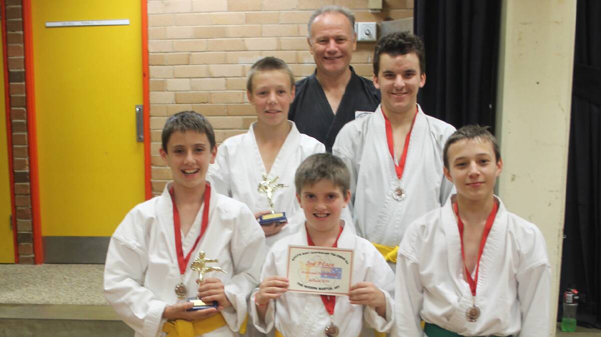  COMPETING WELL: Bringing home a swag of medals and trophies from a recent tournament are (back, from left) Cootamundra tae kwon do instructor Shayne Wilson and students (second row) Tyronne Owen and Matthew Ryan (front row) Daniel Perry, Michael Perry and Lachlan Riske. 