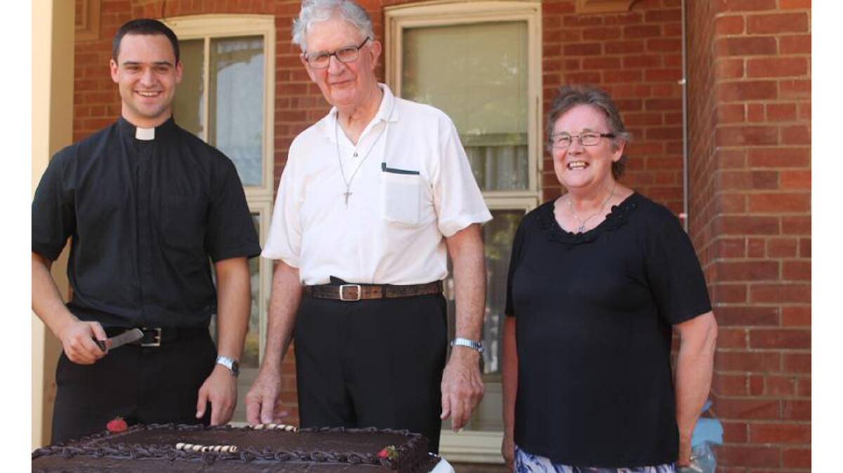 Pictured with Fr. Kevin cutting his farewell cake are Fr. Paul Nulley and the ‘backstop of the parish community’ Sr. Kathy Hodge. 
