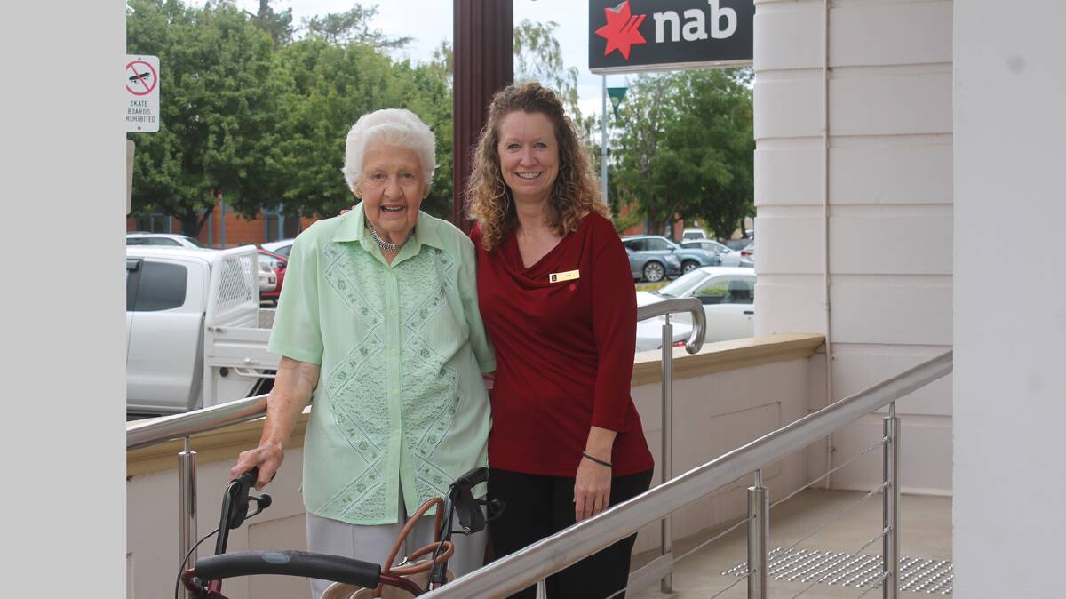  IMPROVEMENT: Pictured using the new disabled access ramp at the NAB building are Cootamundra resident Beryl McPhail (left) and NAB manager Iona Derrick. Beryl was one of the catalysts to seeing the disabled access ramp installed at the bank.  