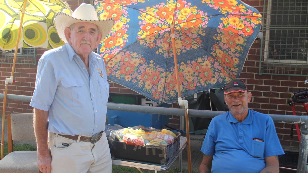 VOLUNTEERS: Russell Hale (left) and Bill Nash sell raffle tickets during Sunday’s monthly markets at Fisher Park, which were the first markets of the year. The markets are hosted by the Cootamundra Wattle Country Music Club with proceeds donated back to the community. New and used items are for sale at the markets and there is a barbecue and drinks as well as good entertainment. The markets are always held on the second Sunday of the month between 9am and 1pm.
Photo: Melinda Chambers 
