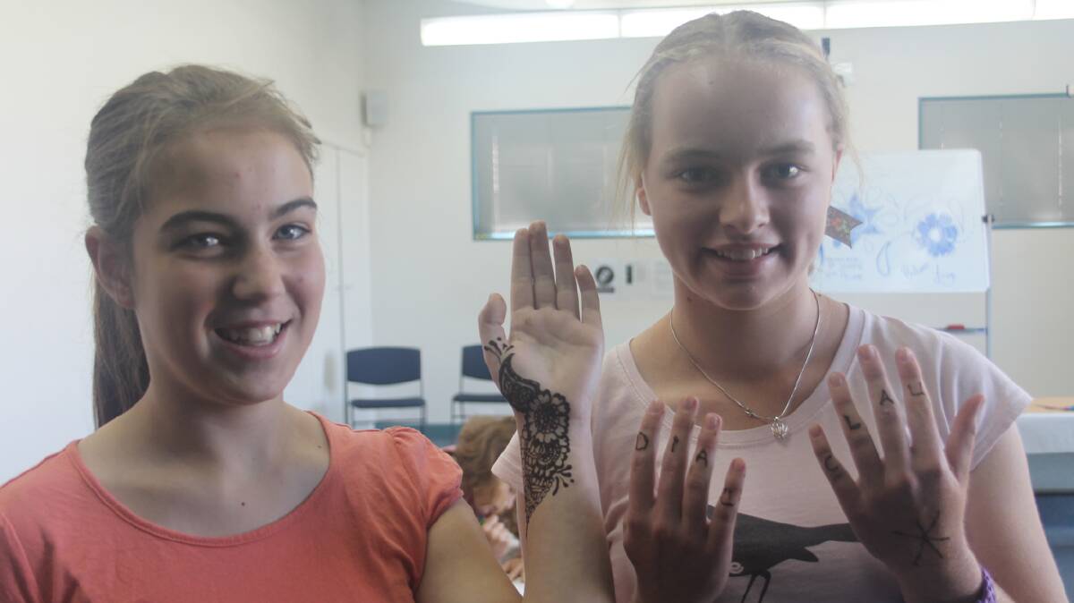 FINE ART: Pictured at the Cootamundra Library’s Henna and Body Art workshop this week were Kimberley Schade and Claudia Walker. The holiday workshop was a sell out.
