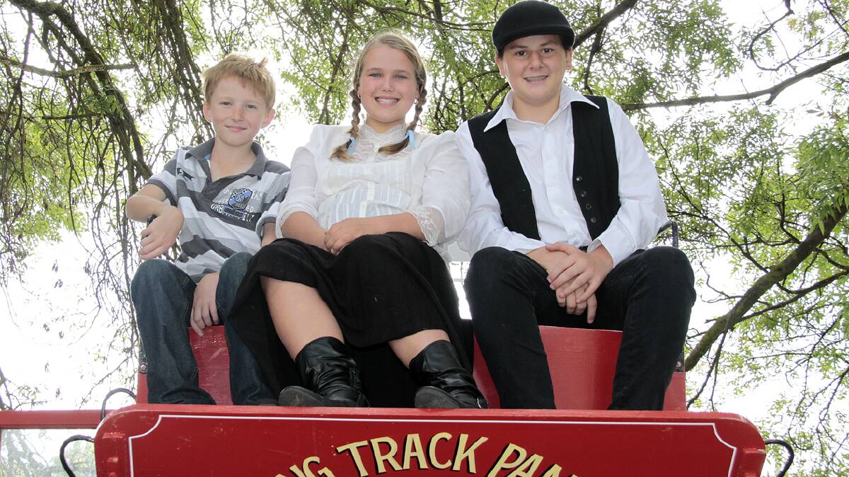 ON BOARD: On the back of the coach are (from left) Tim Lott, Eliza Cooper and Mackenzie Bird.