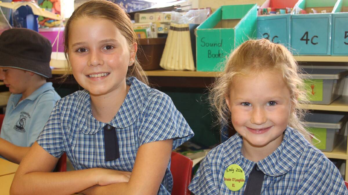 HELPING OUT: Cootamundra Public School student Olivia Hamilton (left) with Brooke O’Loughlin who had her first day at the school on Monday. Each of the new kindergarten students was paired with a member of the year 5/6 class as part of the school’s buddy program.
