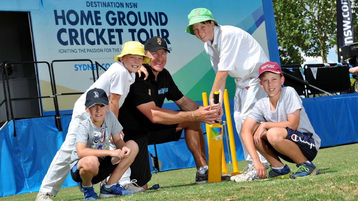 Cricketing legend Andy Bichel will be in Cootamundra today for the Home Ground Cricket Tour, which is hitting 27 regional towns in the lead up to the 2015 Cricket World Cup. Andy is pictured here at the start of the tour with some excited local kids in Dubbo. Photo: Destination NSW.