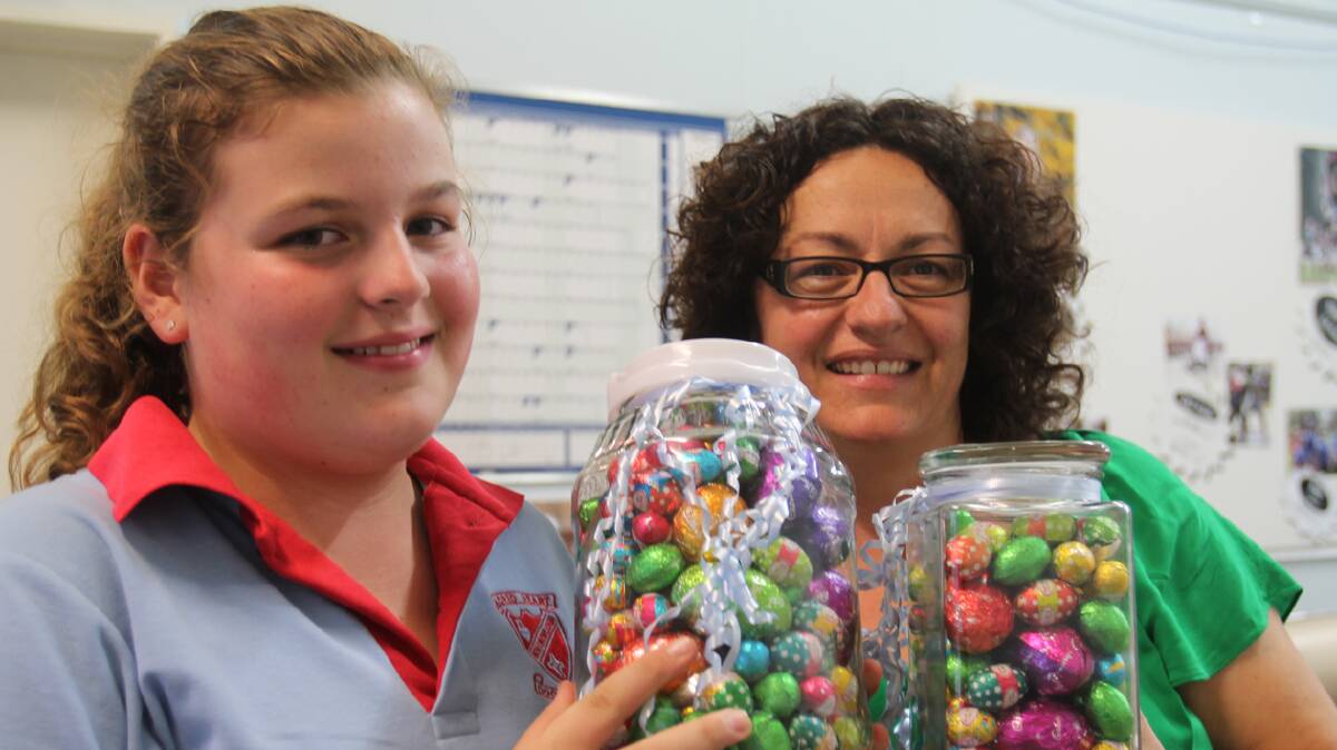  TAKE A GUESS: Call into the Cootamundra Herald and guess how many eggs are in these two jars. All proceeds will go to Cootamundra Riding for the Disabled. Pictured with the jars are Herald staff member Rachel Fitzgerald and daughter Lucy.