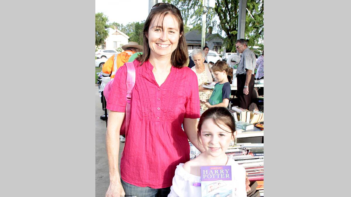 READING ENTHUSIASTS: Roanna Pepper with daughter Jade checks out the wares on offer at the book stall at the Sacred Heart fete.
