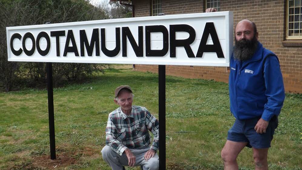 BETTER THAN NEW: Kevin Stewart and Cr Craig Stewart refurbished this Cootamundra Railway sign for the Heritage Centre.