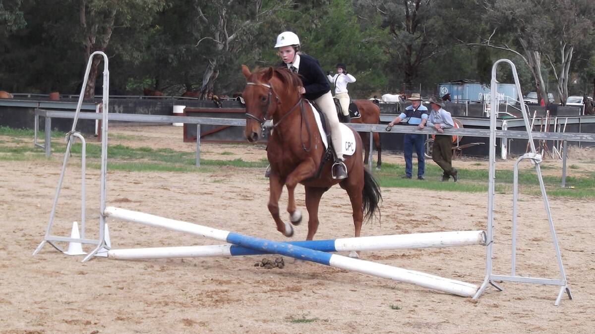 GOOD EFFORT: Sarah Edwards is pictured show-jumping during a recent event representing the Cootamundra Pony Club. 
Photo: Julie Roberts  
