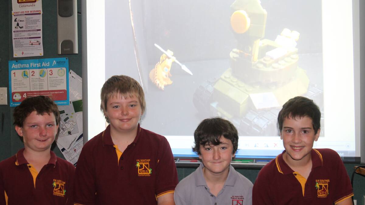 LEGO CREATION: pictured (from left) are EA Southee students Dylan Vivian, Jeremy Frost, Tim Nelson and Mitchell Smith in front of one of stills that they used in their video about World War II.