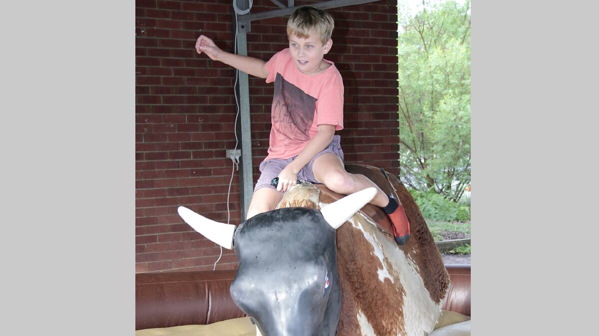 LOADS OF FUN: Jack Ruskin has a go on the mechanical bull at the Sacred Heart fete.