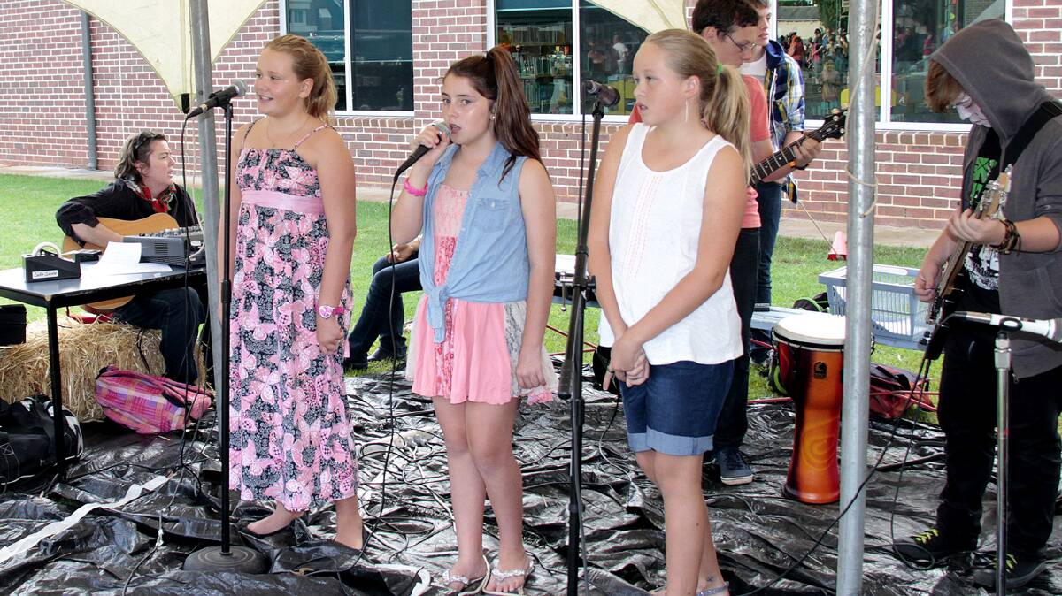 PROVIDING ENTERTAINMENT: Year Six Sacred Heart music students (from left) Lauren Mays, Kate Jenkins and Sianne Marsay–Turner entertained the good crowd on Friday night.  
