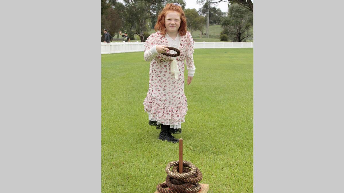 HAVING A GO: Chloe Anderson of Wallenbeen enjoys the quoits at the Wallendbeen Red Cross Centenary Fair on Saturday. 
