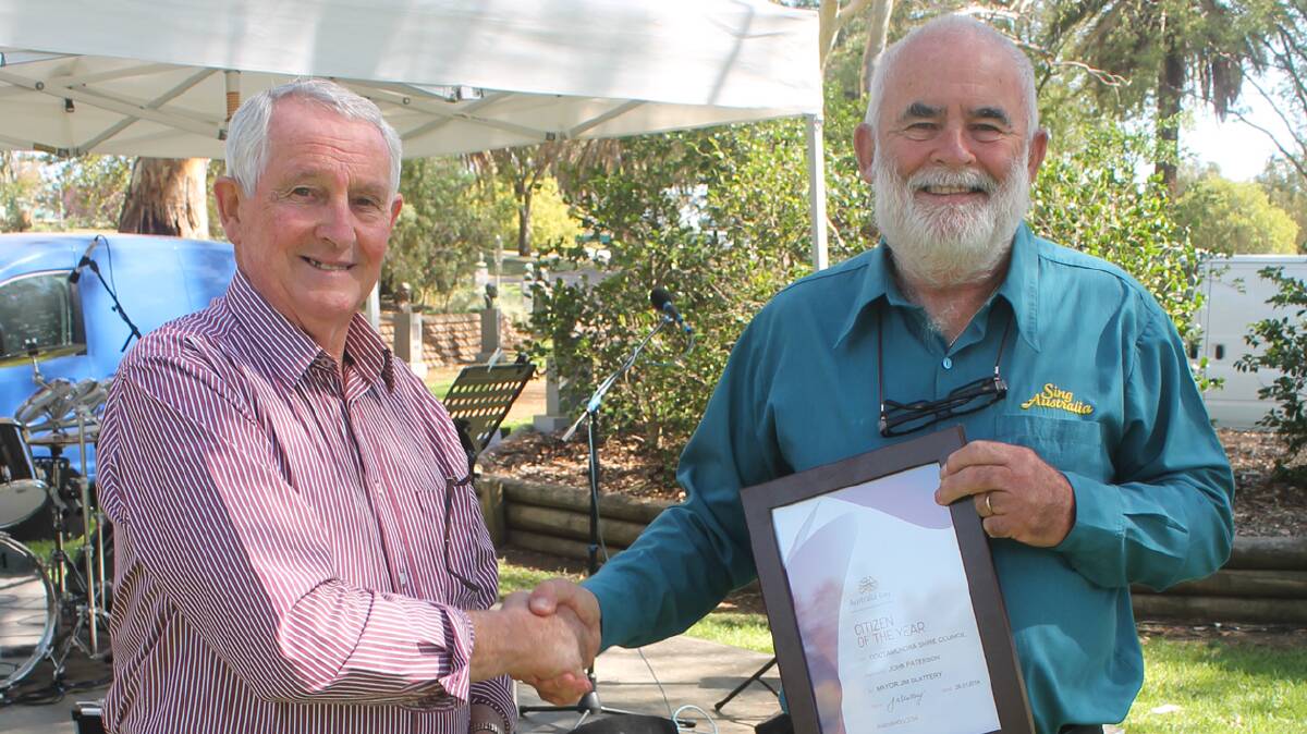  AN HONOUR: Cootamundra Citizen of the Year for 2014 John Paterson (right) accepts his award from mayor Jim Slattery. 