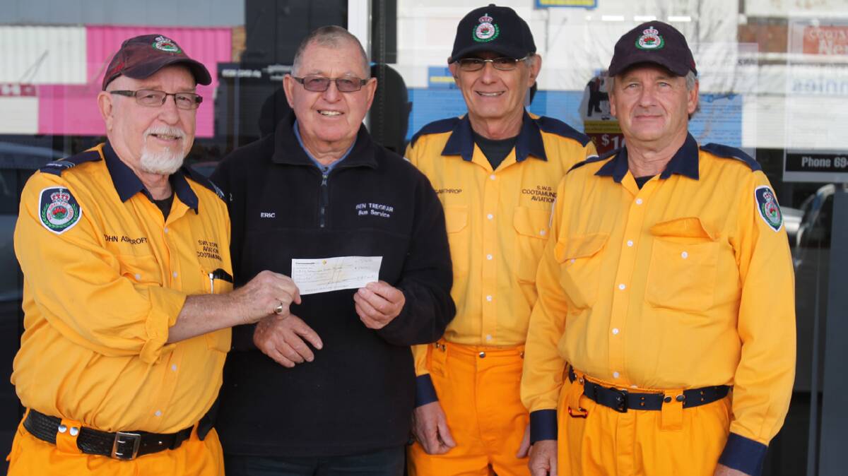 WITH THANKS: Cootamundra Rural Fire Service Aviation Brigade captain John Ashcroft (left) accepts a cheque for $2300 from Lions Club member Eric Thorburn with Bryan Gawthrop and Bruce Smith on hand for the Aviation Brigade to show their thanks.   