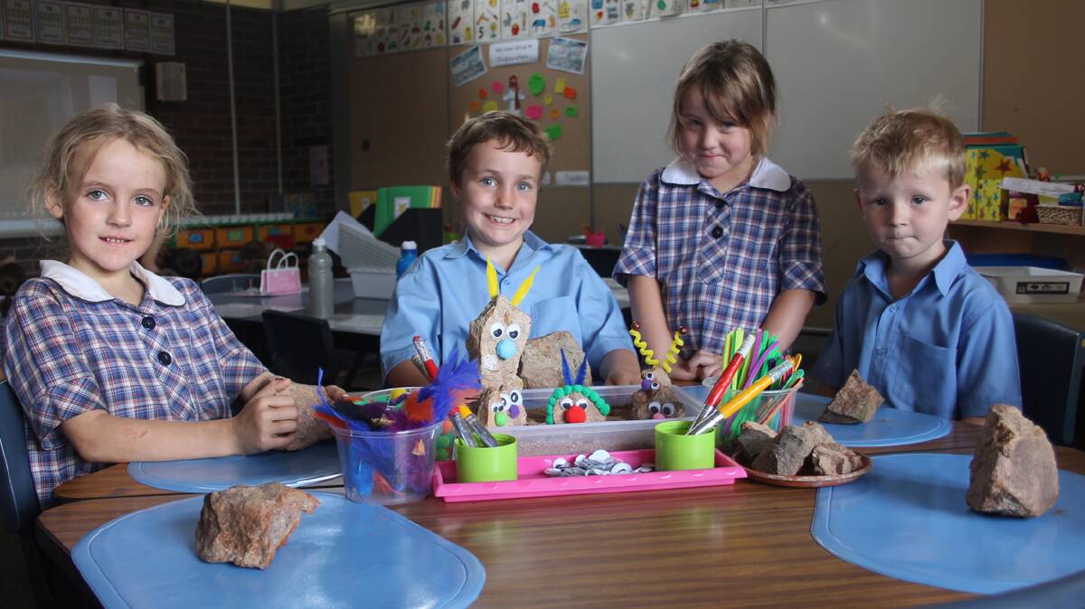  ADOPT A ROCK: Pictured preparing their rocks for the Adopt a Rock stall at the Sacred Heart Central School next month are (from left) Hannah Drum, William Benson, Jada Parkinson and Henry Hazlett.