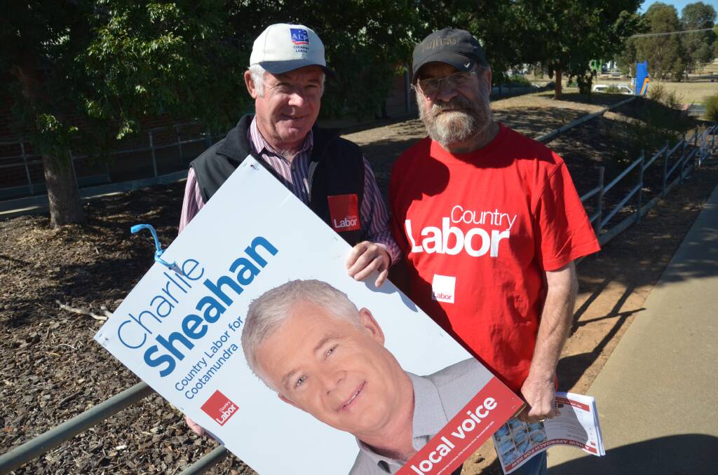 Cootamundra candidate Charlie Sheahan with volunteer Alex Deacon at the polling station at Junee High School. Picture: Declan Rurenga