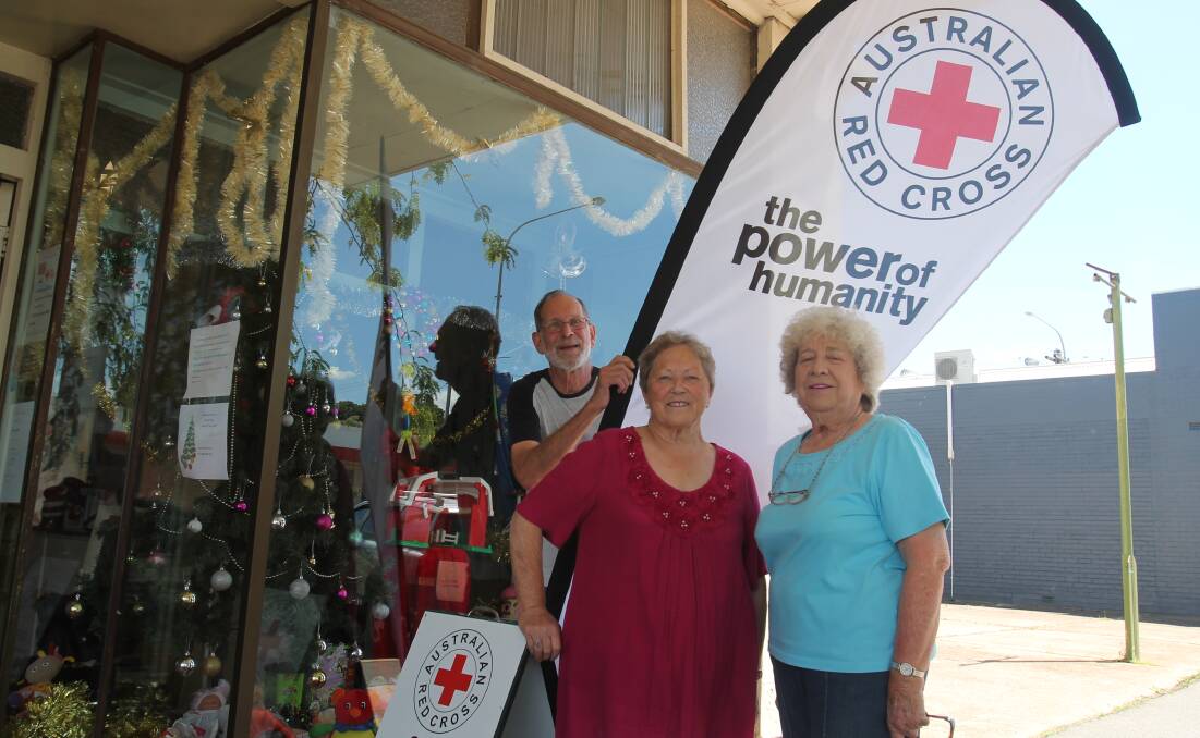HONOURED: Cootamundra Red Cross branch has been recognised for its fundraising efforts, pictured are treasurer David Ainley, shop co-ordinator Helen Eccleston and branch president Betti Punnett. Photo: Declan Rurenga