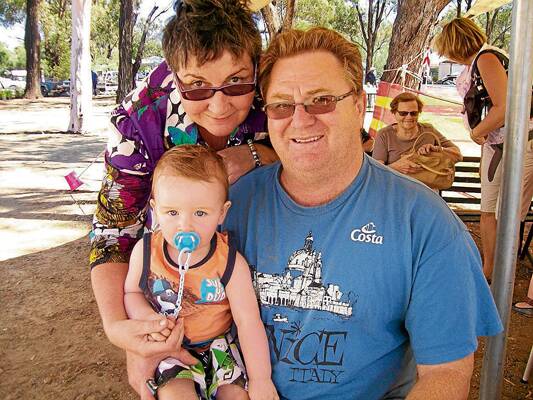 AT THE FAIR: What a cute photo of a happy family enjoying the Stockinbingal Fair, which by the way was a resounding success. Proud grandparents Glen and Janet McAtear are pictured with their grandson Brock McAtear.