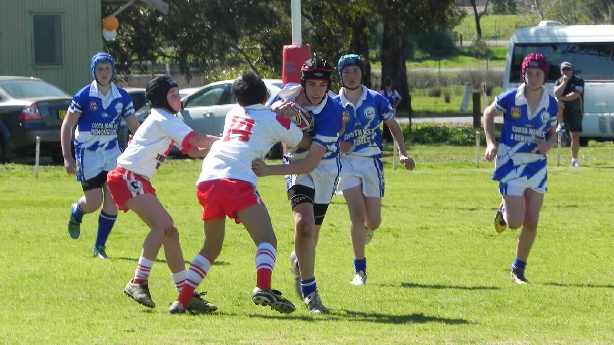  ATTACKING PLAY: James Howse, supported by James Wilson and Josh Deep makes a run in last weekend’s under 13s Bulldogs win against Temora.  Photo: Sue Caldwell 