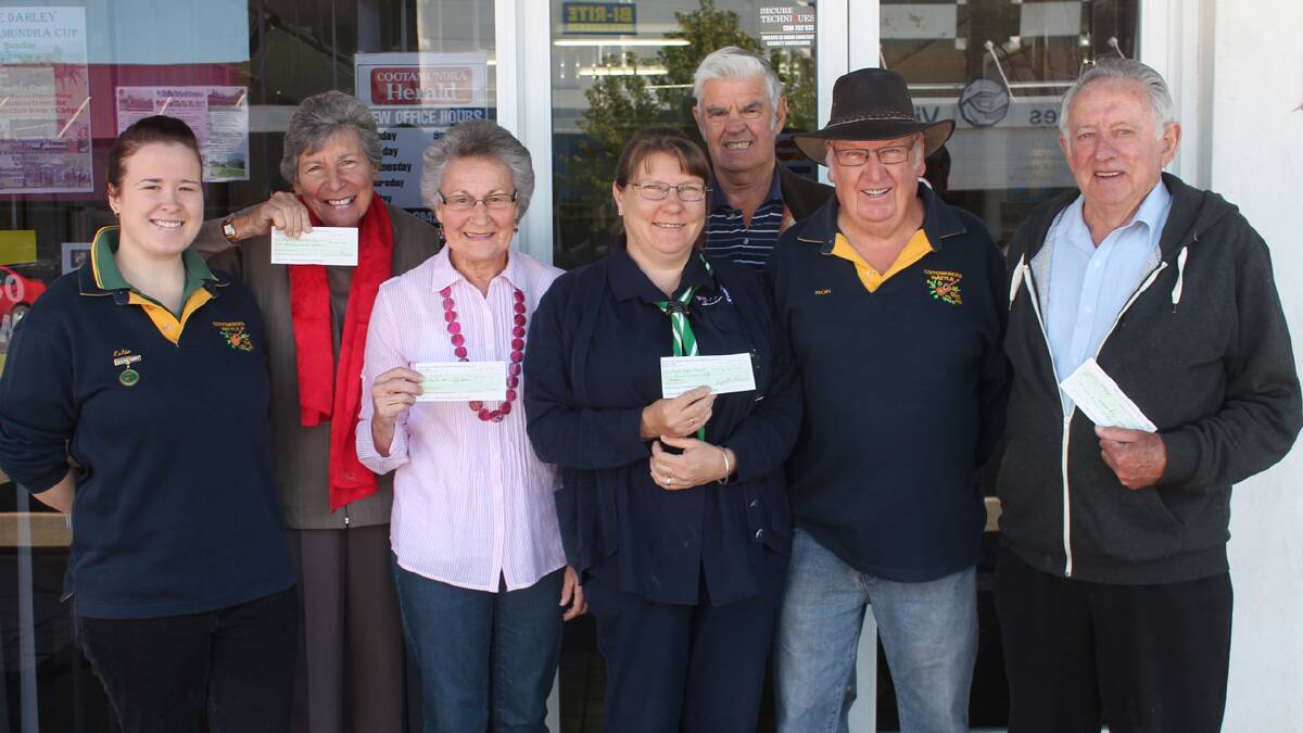 WITH THANKS: pictured during the handover of proceeds from the Monthly Markets hosted by the Cootamundra Wattle Country Music Club are (from left) Music Club secretary Katie Gould, Jenny McClintock from the Hospital Auxiliary, Doreen O’Connor of Riding for the Disabled, Marjory Tapprell and Russell Wray from Scouts, Music Club president Ron Owen and Neil Murray representing Can Assist. 