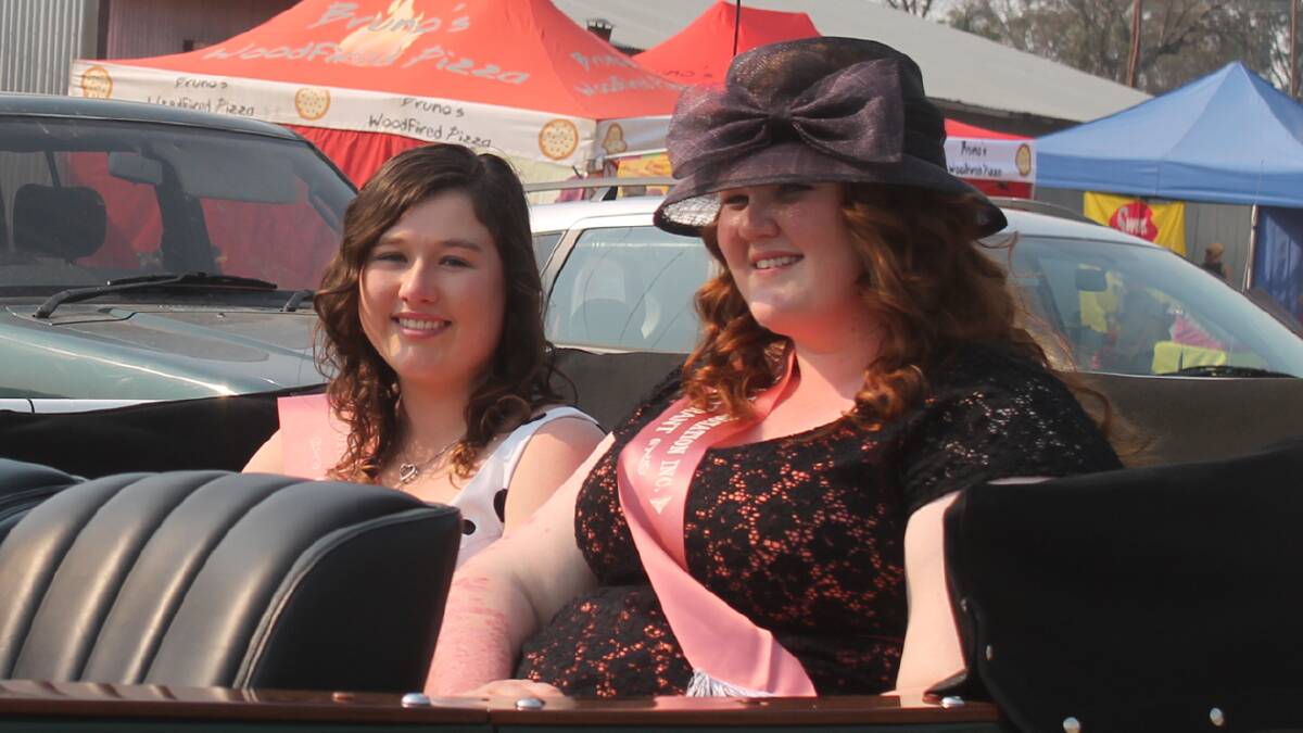 LOOKING LOVELY: In a vintage car as part of the parade following the show opening are Showgirl entrants Charlotte Thompson (left) and Anna Ingold. 