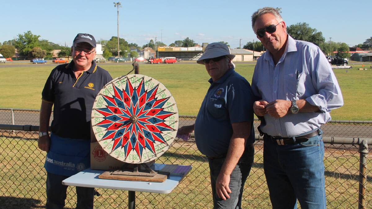 BUSY: Pictured selling tickets for the ever popular chocolate wheel at the Lions Club Christmas Carnival on Saturday night (from left) Phil Quarmby, Robert Armstrong and Dennis Palmer.