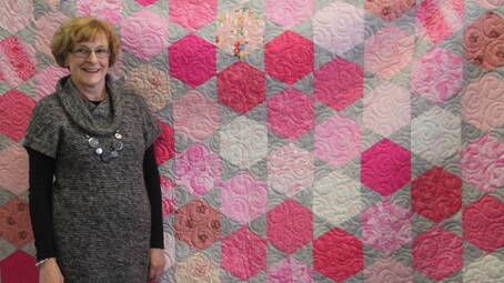 Pictured here is Robyn Harris in front of her latest patchwork creation – this magnificent, impressive, wonderful quilt has been made with ‘special love’ to be raffled on Pink Ribbon Day.