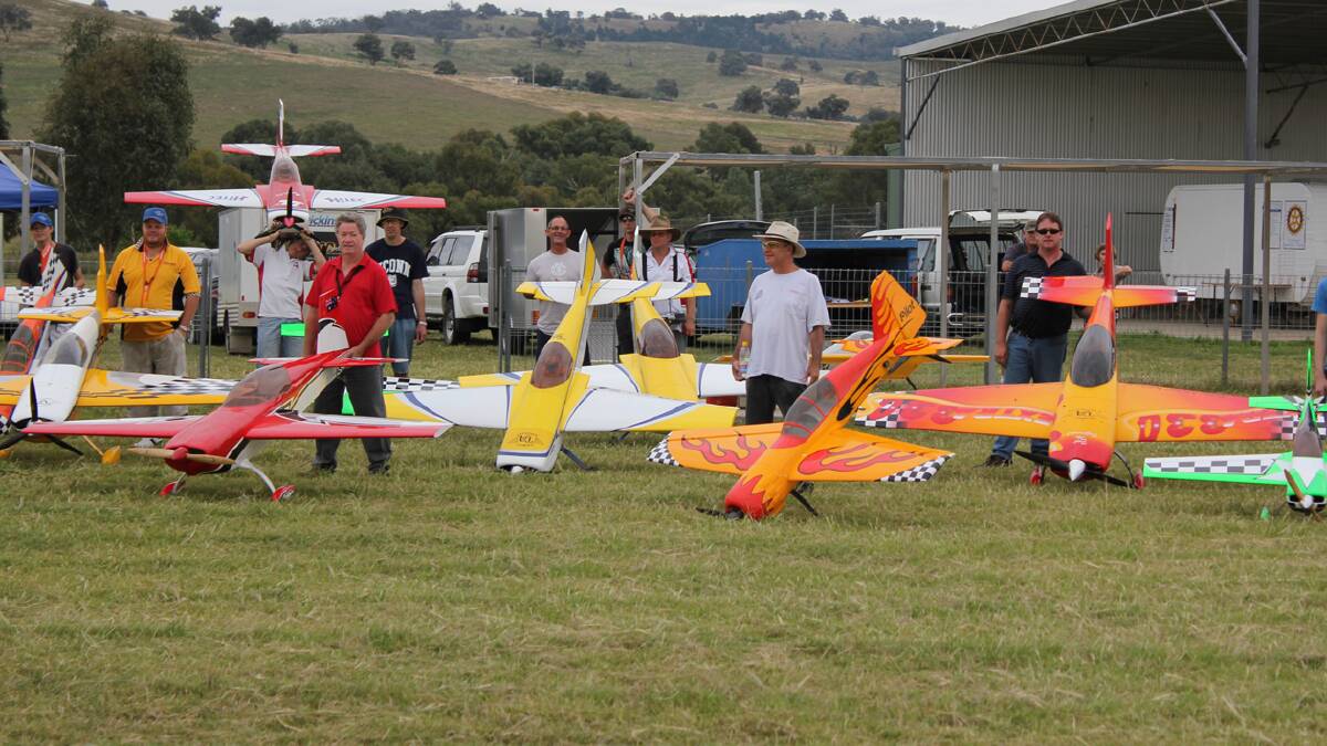 UP IN THE AIR: Pictured are scale modellers at a recent Cootamundra competition. This weekend will see a scale model acrobatic event at the Cootamundra Flying Field.