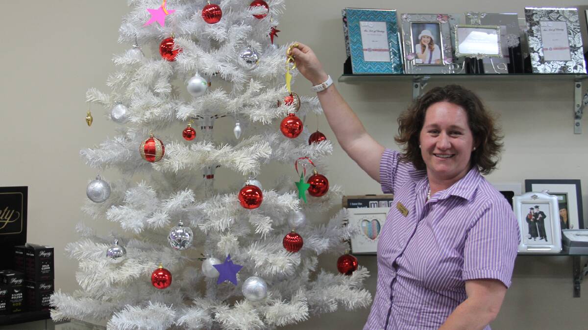  SPECIAL TREE: pictured is CW Jewellers employee Cathy Manwaring with the Can Assist Memory tree. Anyone who has lost a loved one in the past year can buy a star for $2 which will then be put on the tree. On the last Thursday before Christmas, a balloon for each star will be released from a location within town. The stars will be sold from this Thursday.