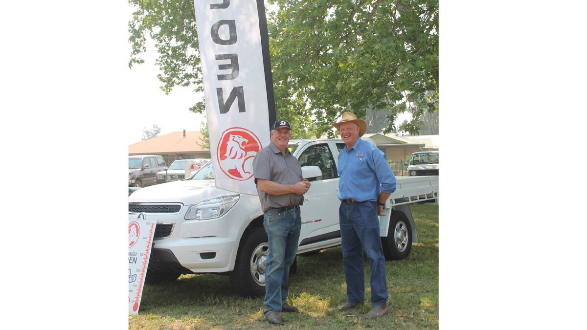  SPONSORS: Agland Industries operations manager Peter McPhail chats to the Coota Show’s Graham Butt outside the Cootamundra Holden stand at the show on Saturday.   Photo: Melinda Chambers 