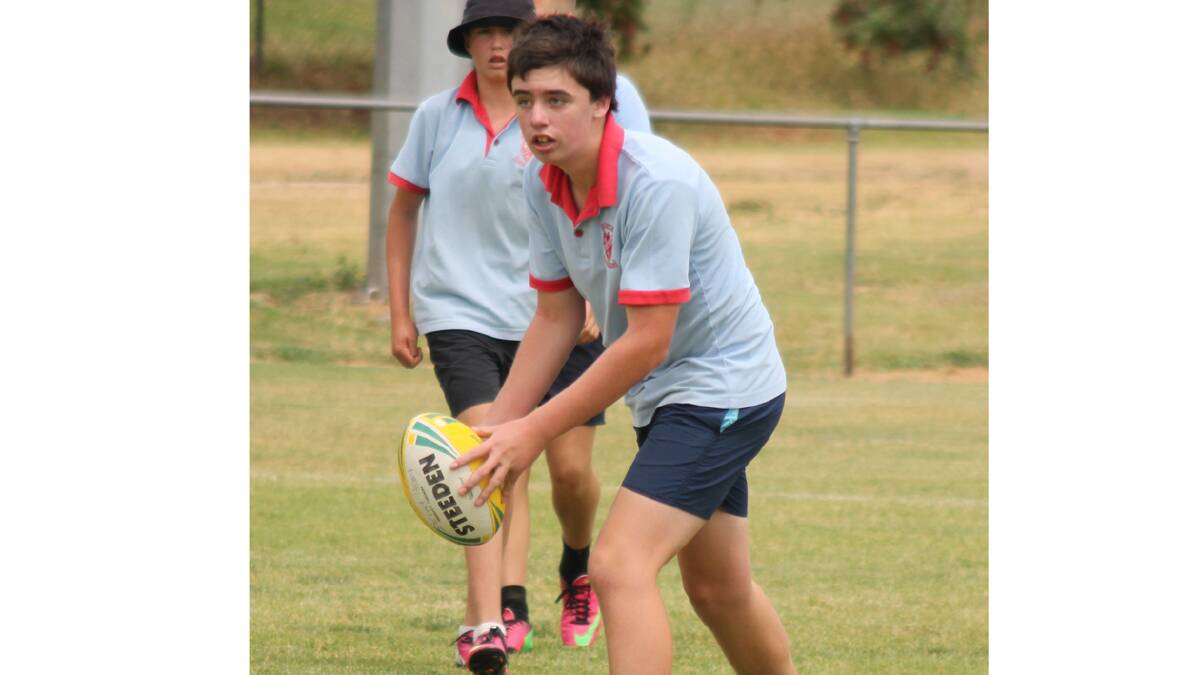  ASSESSING HIS OPTIONS: Sacred Heart student Sam Stewart plays in Cootamundra’s Annual Secondary Touch Football Carnival.