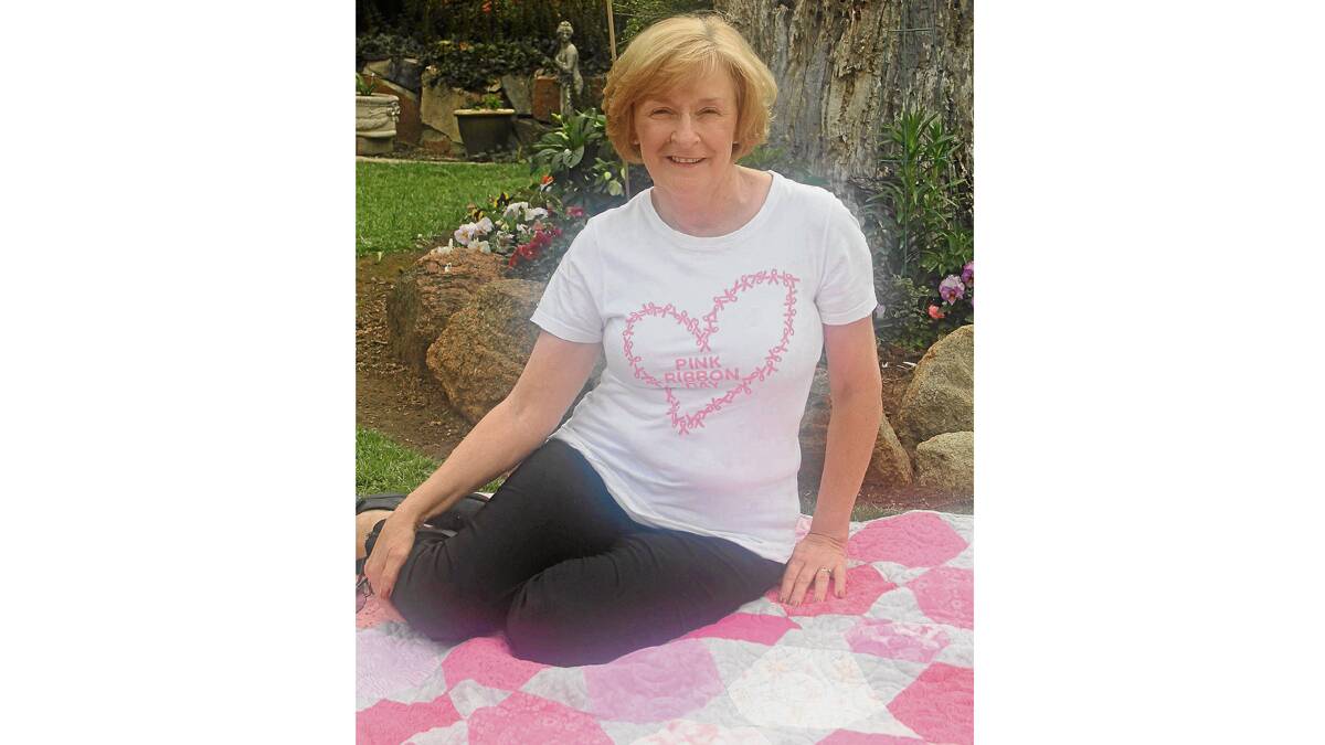 HEALTHY AND HAPPY: Robyn Harris, pictured in her backyard on a quilt she is raffling for the Cancer Council, is calling on all women who been affected by breast cancer to go along to next Tuesday’s Breast Cancer Support Network lunch at E’Claires Coffee Shop from 12.30pm. All are welcome.