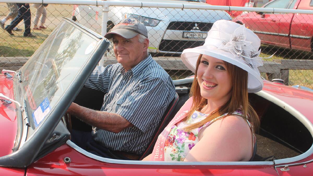 LOOKING LOVELY: Cootamundra Showgirl entrant Cassie Parkinson and Cootamundra Antique Motor Club member John Rickett get set to take off during a parade featuring vintage cars and the Showgirls after Saturday’s official opening of the Cootamundra Show. 