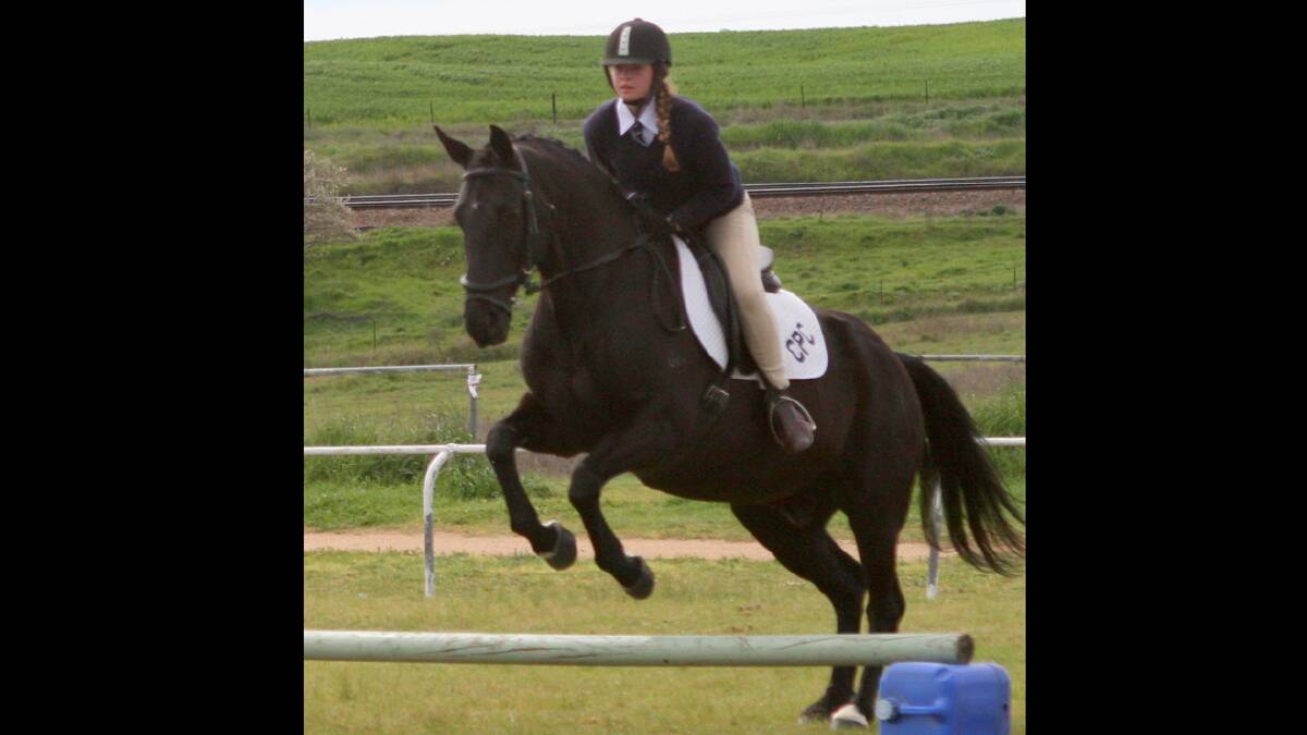 GRACE AND POWER: Lara Southwell jumping in the sporting events on her horse Charlie. 
