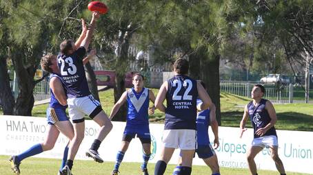  LEAP: Dean Bradley uses his height to clear the ball at Clarke Oval on Saturday.   Photo: Louise Leahy 