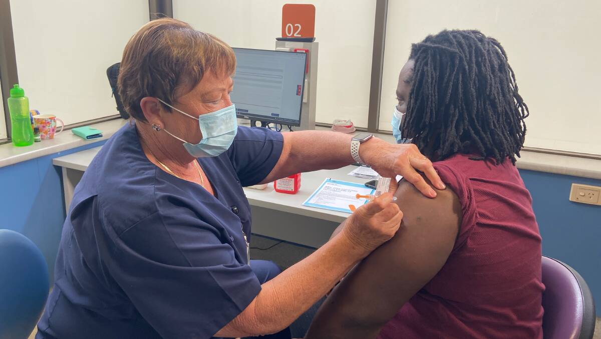 DOUBLE DOSED: Tapiwa Kanduka receives his second COVID-19 vaccine shot in Wagga on Wednesday. It was the 50,000th jab administered by the MLHD.
