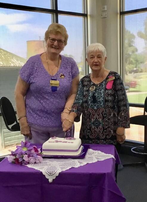LONG-SERVING: Jenny McAinsh and Audrey Taber, recipients of 20-year membership pins, had the honour of cutting the club's birthday cake.