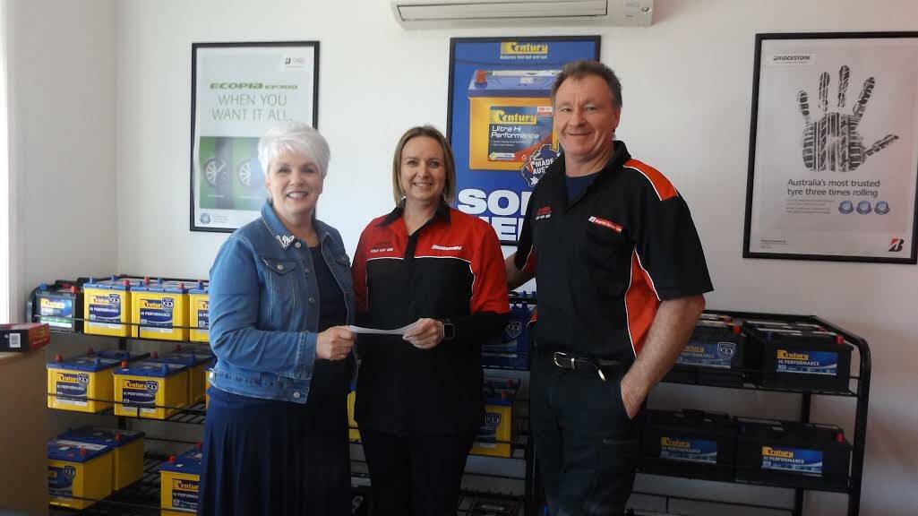 Can Assist Treasurer Colleen Flynn accepts a very generous cheque from Jo and Dave Harris from Harris Tyre Service.