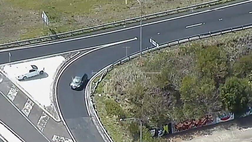 Polair vision shows the dramatic moment two men, accused of embarking on a crime spree across southern NSW in recent days, were chased down and arrested in Figtree on Monday. Pictures: NSW Police