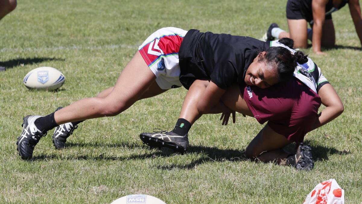 NEW CHALLENGE: Bulou Baravilala tackles Janiana Ravu
during the Riverina women's tackle training
at Beres Ellwood Oval on Saturday. Picture: Les Smith
