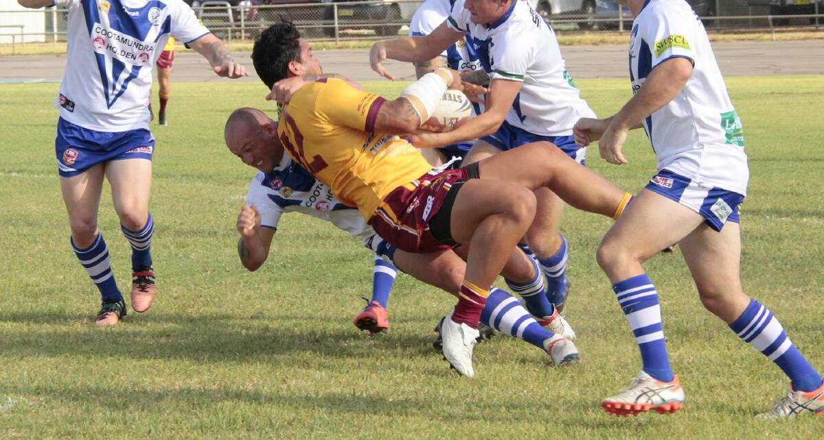 BIG HIT: Rob Tulenew slams former NRL player Anthony Cherrington to the ground during the trial against Thirlmere on Saturday.