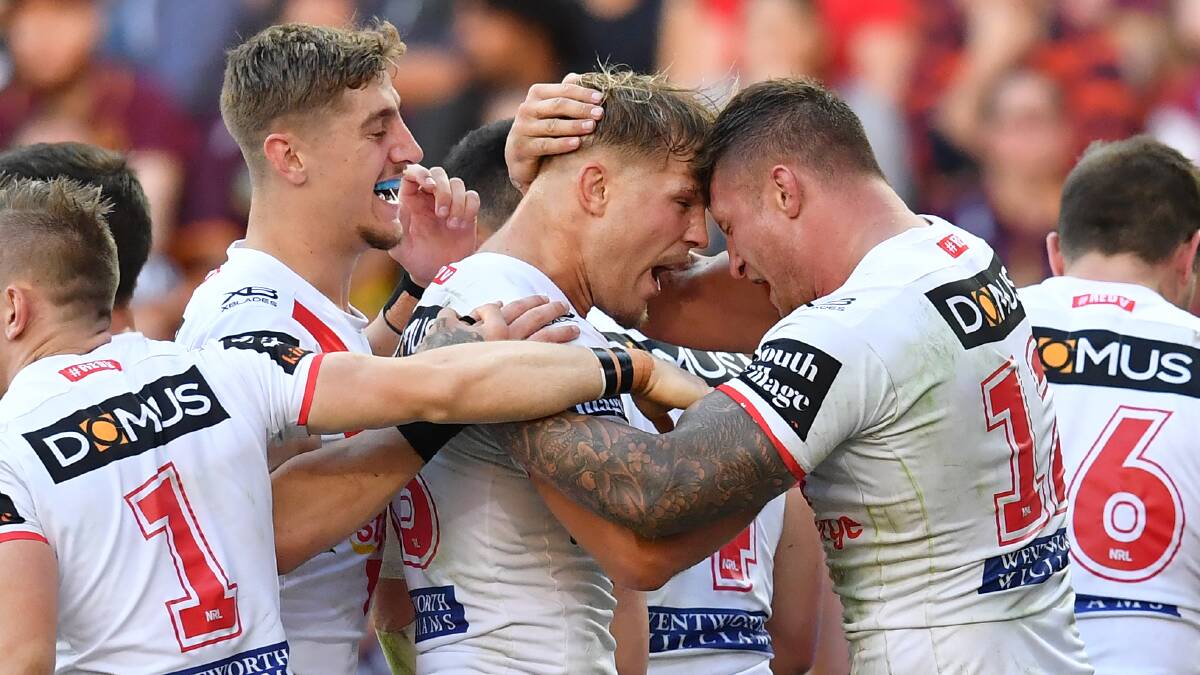 INJURY WORRY: Jack de Belin, pictured celebrating a try with Temora's Zac Lomax (left) and Tariq Sims is in doubt for the Dragons next final against South Sydney.