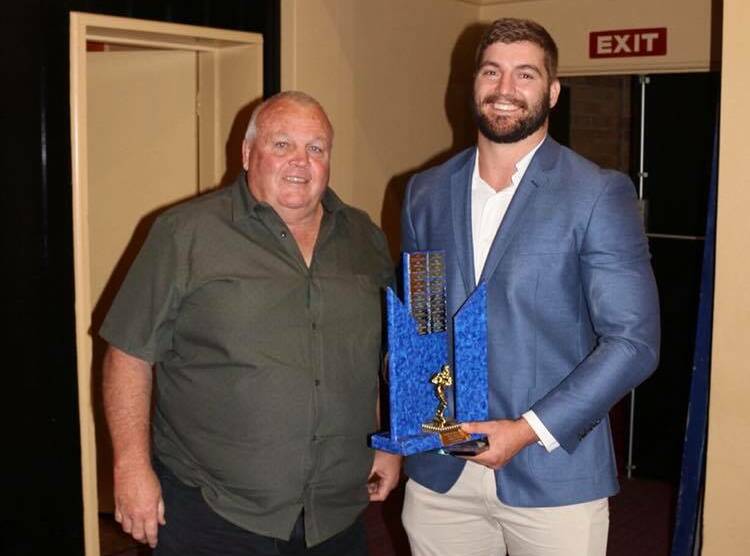 BIG NIGHT OUT: Jake Goodwin is presented the Les Boyd Medal by the former Australian player. It was one of the front rowers three awards on at the Bulldogs presentation night.