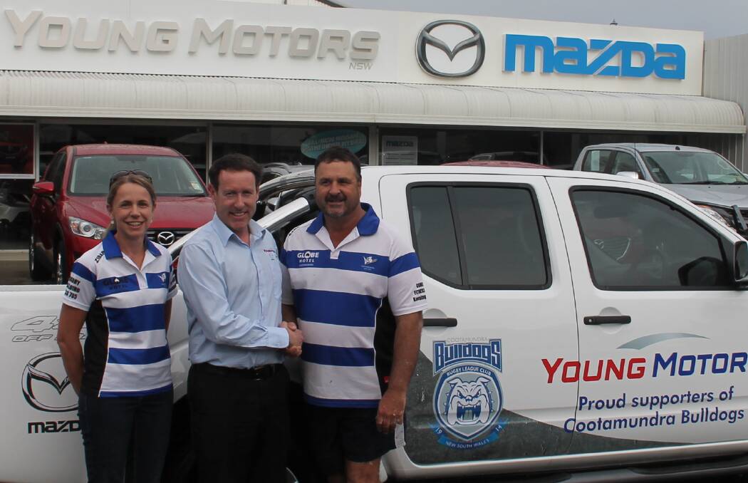 NEW DEAL: Young Motors dealer principal James Clifford shakes on a new deal with Bulldogs president Wayne Berkrey and treasurer Tina Graham. Picture: Katherine Maclagan