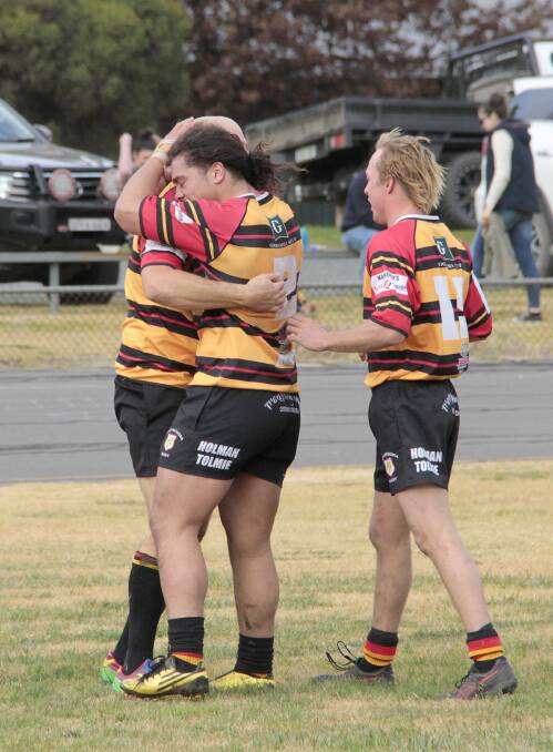 Nathan Corby congratulated by Darryl Hemopo and Paddy Cameron after crossing for a try for the Cootamundra Tri Colours against Grenfell on the weekend.