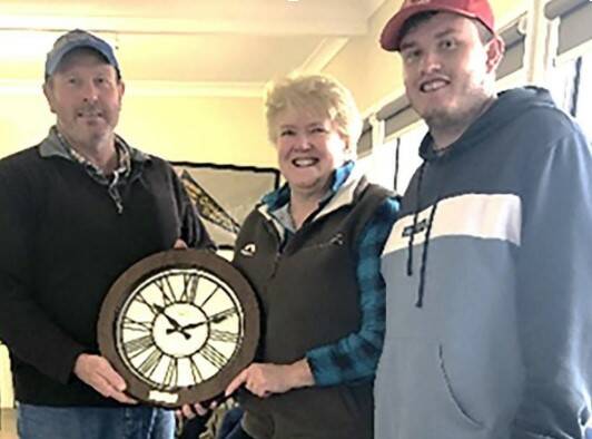 Richie, Ann and Sam Larsen accepting their clock from the Stockinbingal Tennis Club Photo - Sue Caldwell.