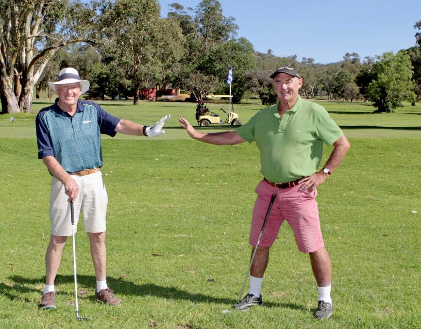 John Brooker and Gerry Bassingthwaighte practicising social distancing at the Cootamundra Country Club last month. Photo by Kelly Manwaring.