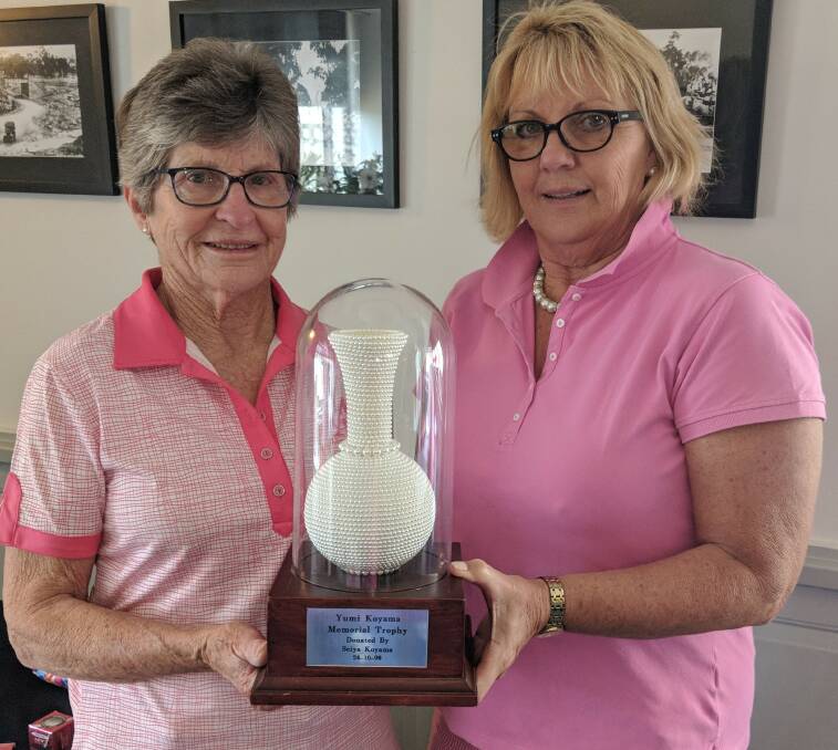Belinda Scott (left) was the overall winner, she is pictured receiving the Yumi Trophy from President Kate.