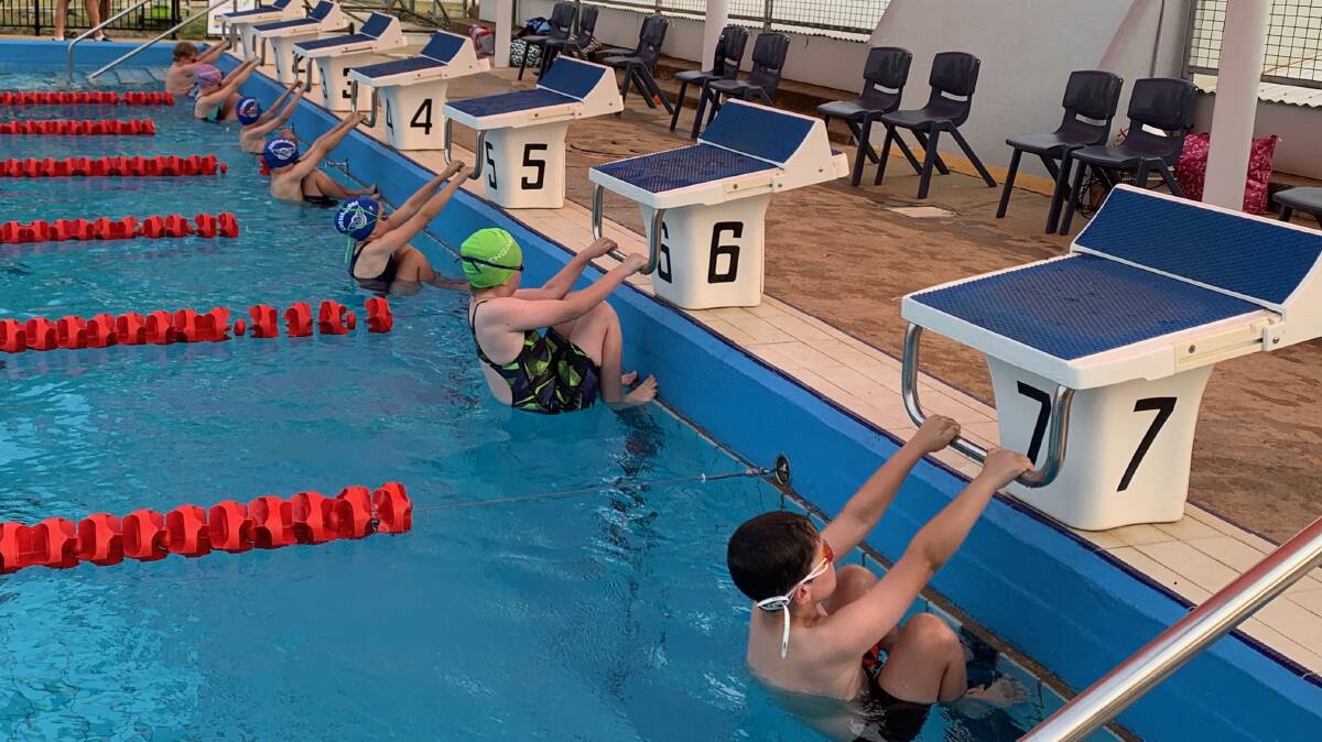 Cootamundra swimmers line up for a backstroke race during the season. The club took out a number of regional awards last season including the Premiership Cup.